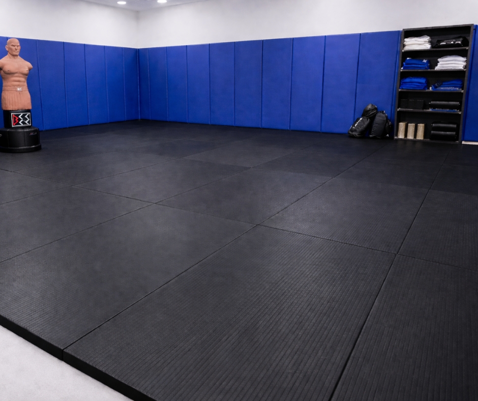 blue wall pads, black judo mats and punching dummie